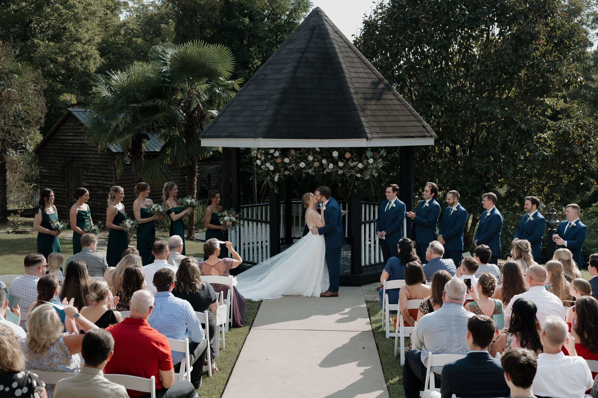 A couple shares their first kiss during their wedding ceremony at the Corley Mill House in Lexington, South Carolina.