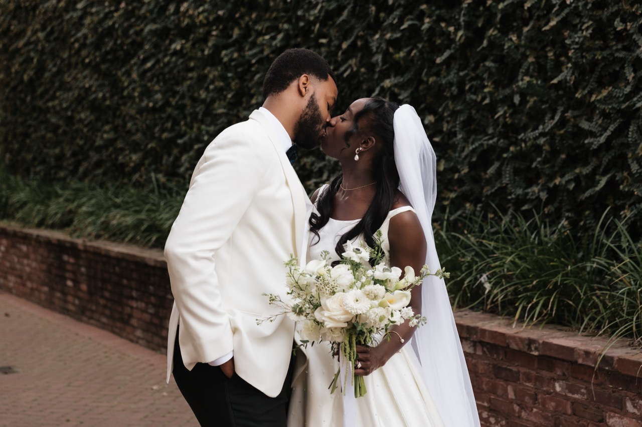 Sydney and Winston share a kiss in the alley at 701 Whaley in Columbia, SC on their wedding day.