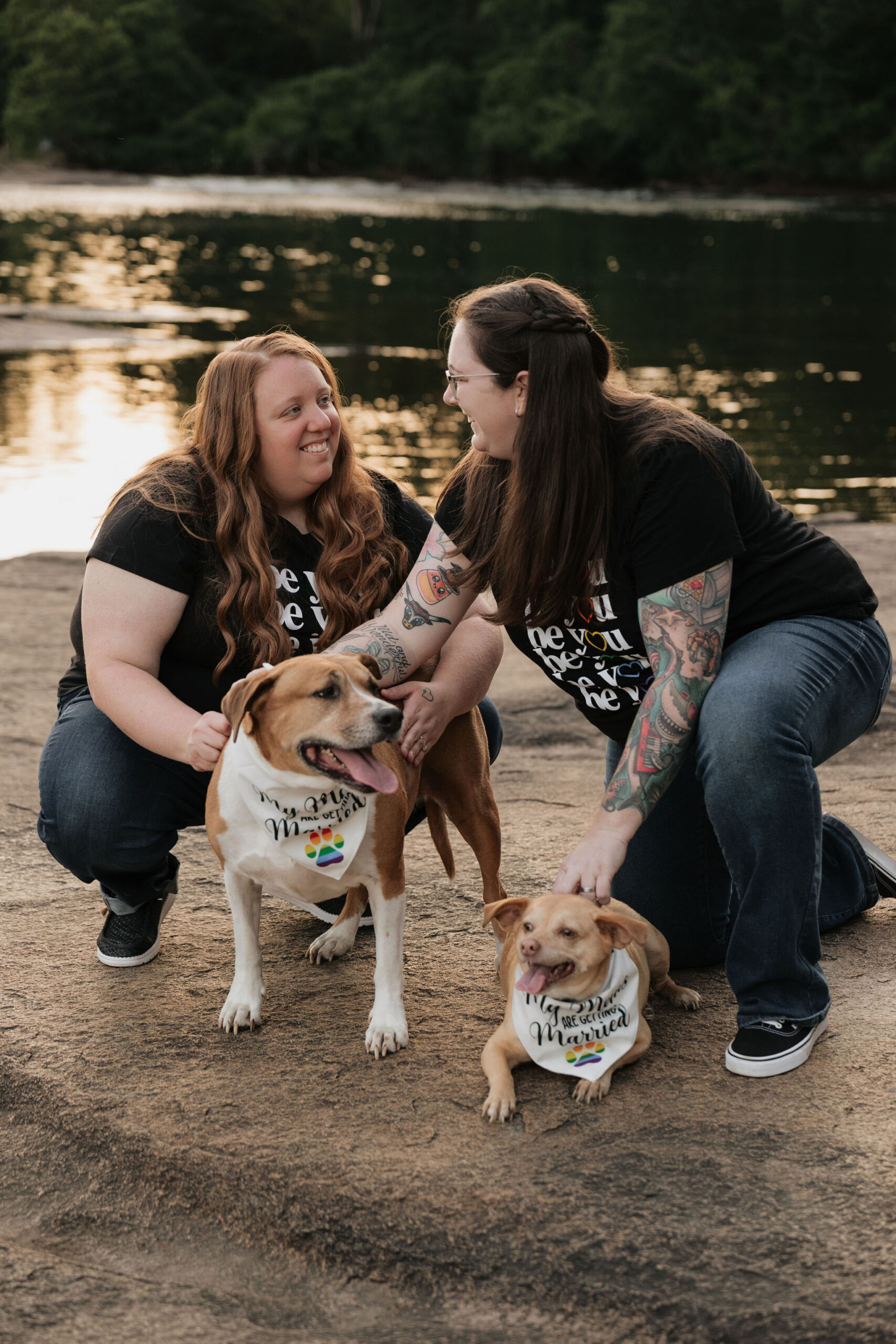 Katie and Ashley play with their two dogs during their Columbia, SC engagement session on the river.