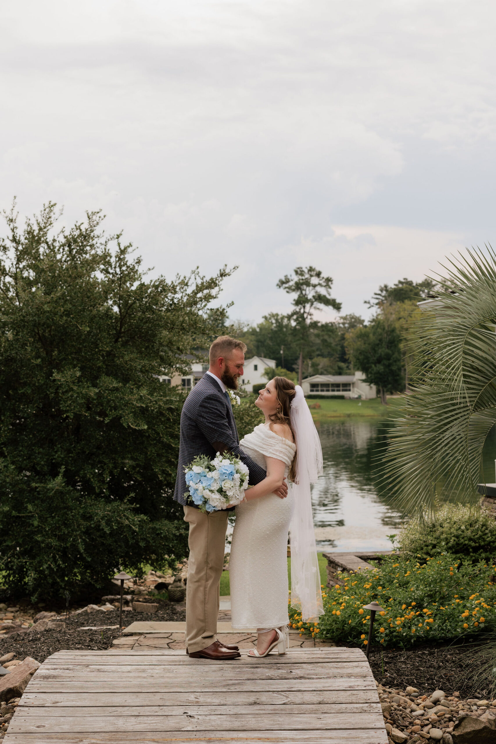 Lauren and Stephen pose for a portrait at a home on Lake Murray in South Carolina on their elopement day.